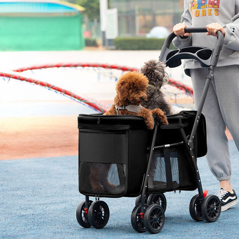 Black foldable pet stroller with mesh sides, four double wheels, and a handlebar featuring cup holders.