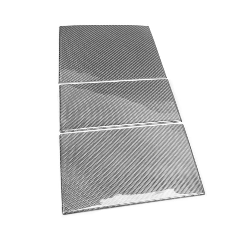 Angled view of carbon fiber panels showing uniform weave pattern.