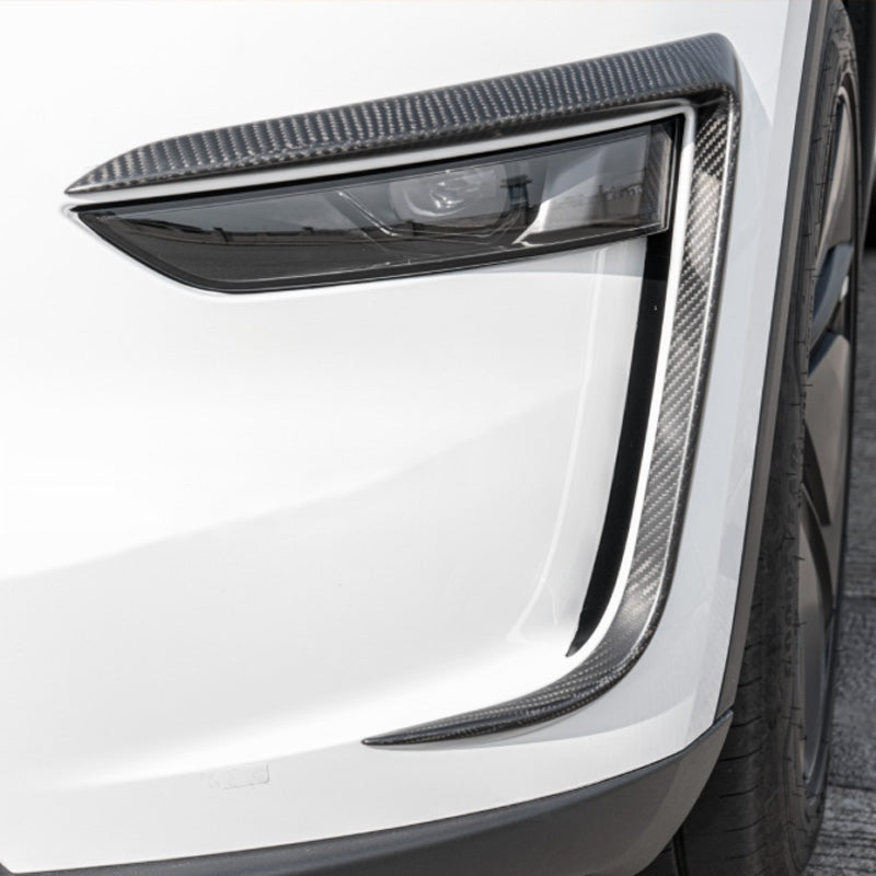 Close-up of carbon trim enhancing the headlight line and depth.